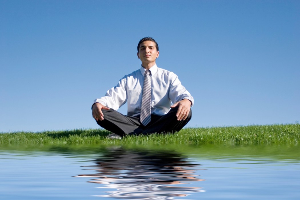 Businessman-meditating-on-gree-11897501